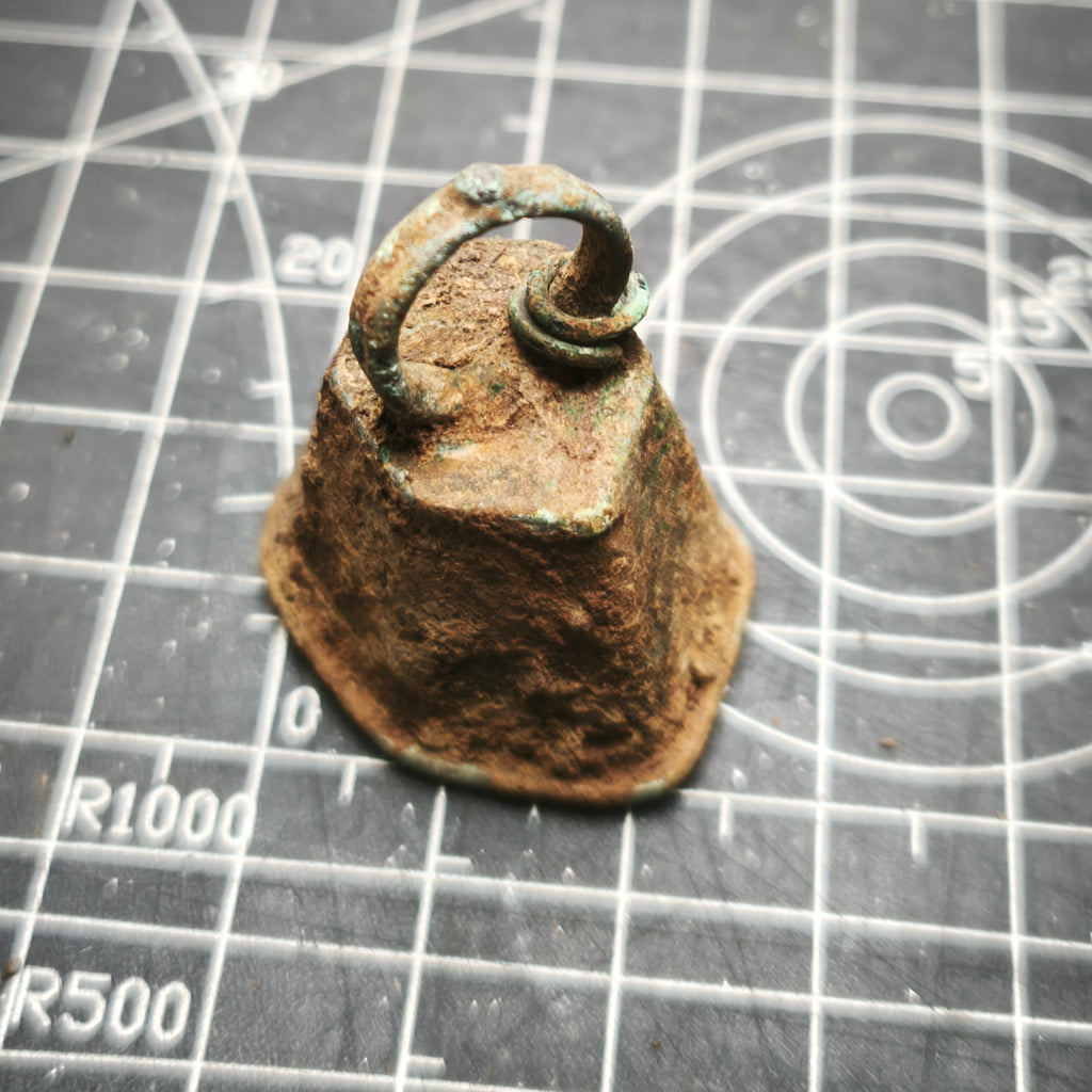 Bronze bell on a grid background