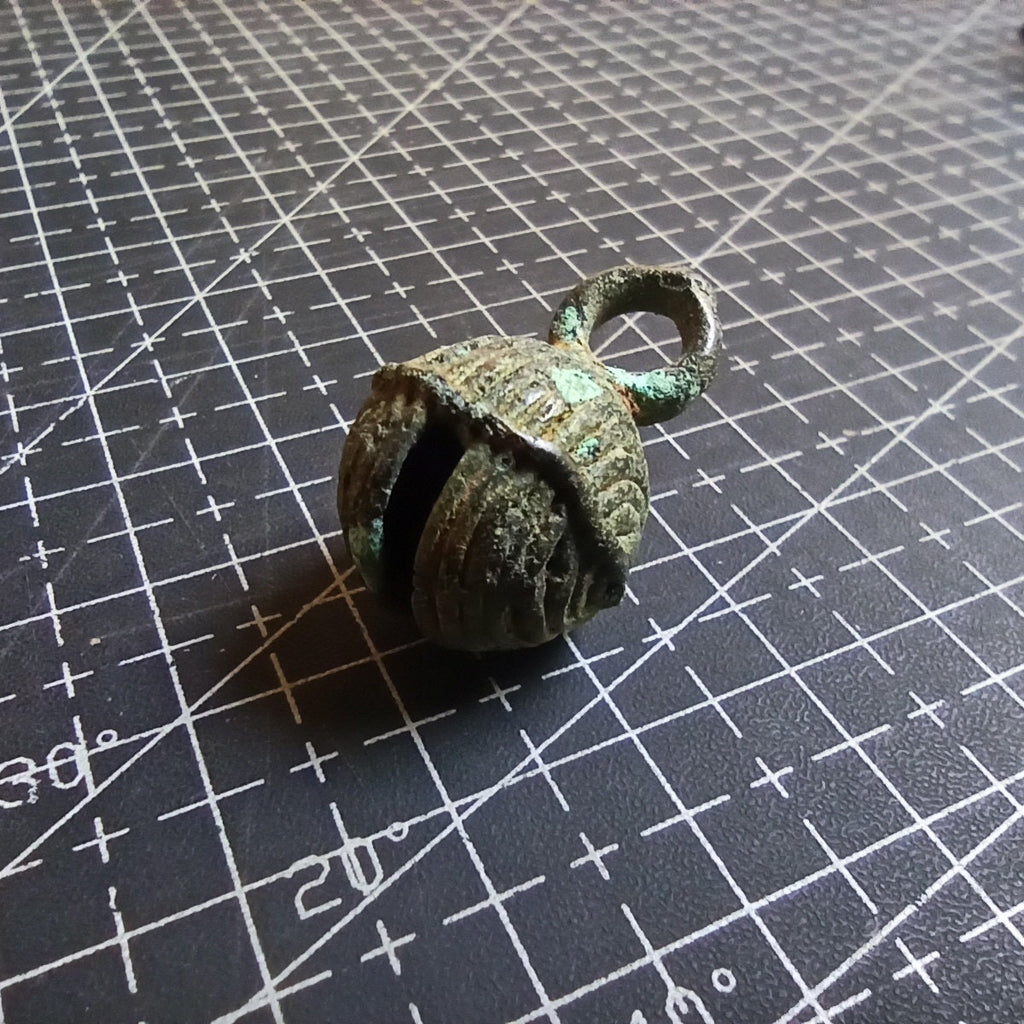 Bronze bell on a grid surface